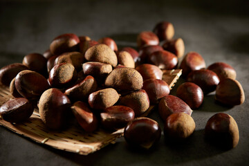 Fresh chestnuts on dark background 