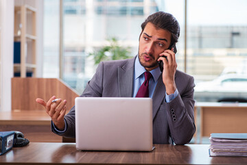 Young male employee working in the office