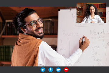 Smiling indian man explaining grammar his female student, e-learning concept