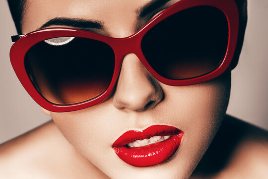 beautiful young woman in red sunglasses