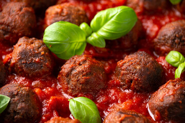 Vegetarian spaghetti with meat free, vegan meatballs in rich tomato sauce in iron cast pan