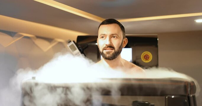 Adult man during cryotherapy in a special capsule. Wellness in a medical spa. Cryo sauna