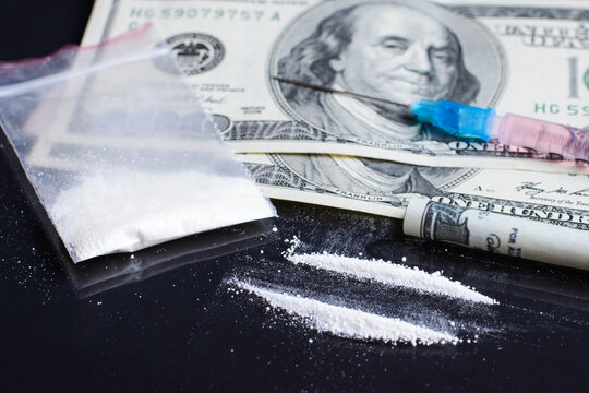 Drug abuse and selling cocine concept. Cocaine lines near money bills