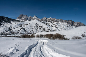 panoramic landscape of winter mountains, passes and snow-covered trees in the Caucasus 