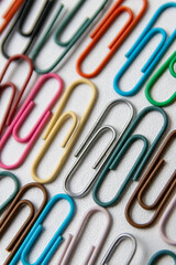 Many colorful paper clips on a home office desk for stationary design as colorful pattern to tidy desk, papers and paperwork to attach attachments to files and documents or collection of office supply