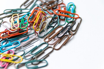 Many colorful paper clips on a home office desk for stationary design as colorful pattern to tidy desk, papers and paperwork to attach attachments to files and documents or collection of office supply