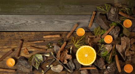 Tło z drewnianych desek wraz z dekoracją liście gałązki kamienie pomarańcz i laski cynamonu