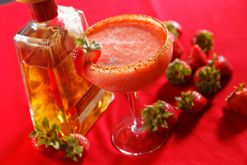 A frozen margarita with tequila and ice slush, and strawberry.