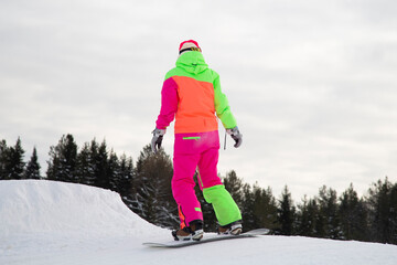 Fototapeta na wymiar A snowboarder on a snowboard. Extreme winter sports.Rest in winter.