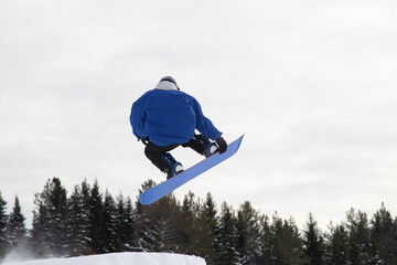 A snowboarder on a snowboard. Extreme winter sports.Rest in winter.