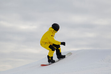 A snowboarder on a snowboard. Extreme winter sports.Rest in winter.