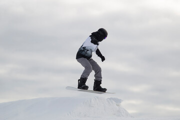 A snowboarder on a snowboard. Extreme winter sports.Rest in winter.