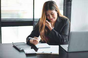 work from home,Portrait of Asian young female working on laptop in home office.