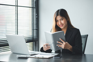 work from home,Portrait of Asian young female working on laptop in home office.