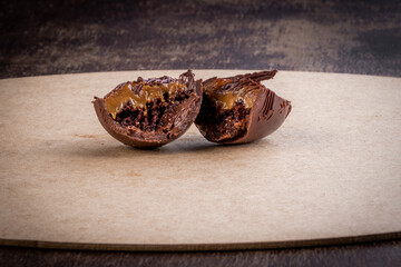 Cracked stuffed chocolate easter egg on a table