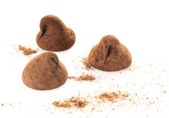 chocolate truffles covered with cocoa isolated on white background, selective focus