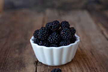 Blackberry. Black berries close-up. Food in a white plate. Place for text