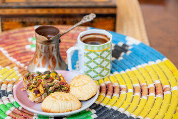 Arabic sweets, maamoul and coffee on traditional background