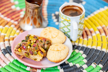 Arabic sweets, maamoul and coffee on traditional background