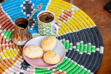 Obraz na płótnie Canvas Arabic sweets, maamoul and coffee on traditional background