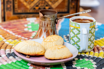 Arabic sweets, maamoul and coffee on traditional background