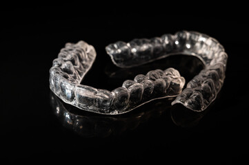 Removable plastic retainers on black background