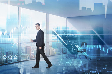 Businessman in office, graphs on background of skyscrapers