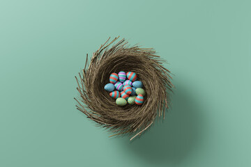 Colored easter eggs in a nest on a green background