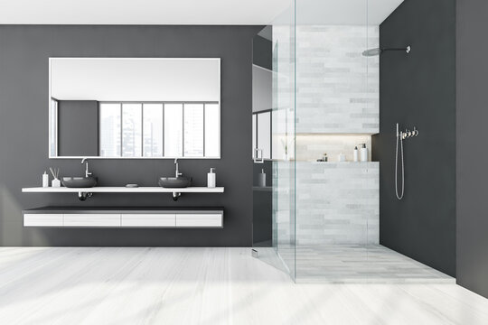 Black and white bathroom with two sinks and shower