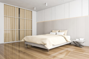 Bed and linens in wooden bedroom with wardrobe