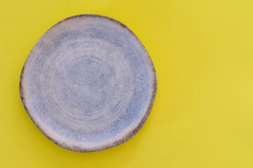 rustic dish on yellow background. Space for text.