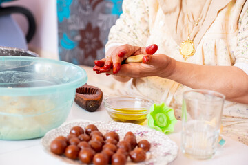 Arabic woman hands making eid sweets ,cookiesand mamoul