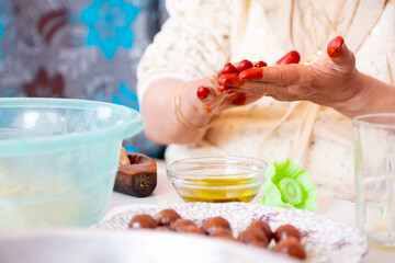 Arabic woman hands making eid sweets ,cookiesand mamoul