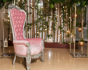 Space decorated with a chair and background lights; Set for taking photos in a social event.