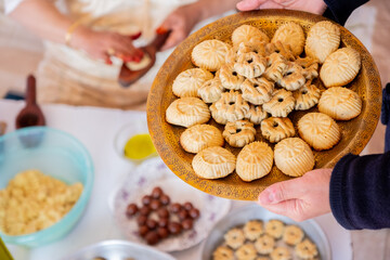 Arabic woman hands making eid sweets ,cookiesand mamoul