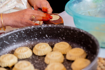 Arabic woman hands making eid sweets ,cookiesand mamoul