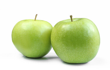 Two whole green apples isolated on white background. Shiny fruits