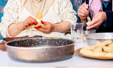 Arabic woman hands making eid sweets ,cookiesand mamoul