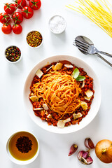 Spaghetti bolognese with minced pork meat and parmesan on white background