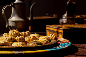 Arabic sweets, maamoul and coffee on traditional background