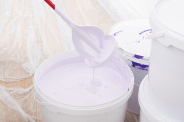 construction mixer finished work in a bucket of purple paint