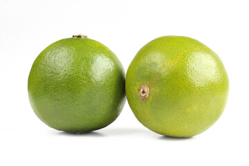Two whole lime fruits isolated on white background