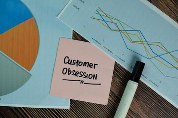 Customer Obsession write on sticky notes isolated on Wooden Table.