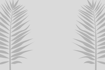 Frame made from tropical leaves. Large palm leaves on gray background with empty space for text