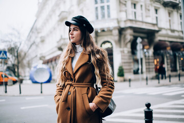 Obraz premium Dreamy woman with hands in pockets