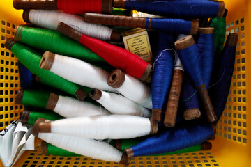 Close-up of multi-colored spools of thread in basket. . Chau Doc. Vietnam.  11.08.2017