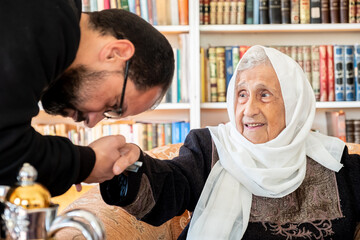Fototapeta na wymiar Arabic family enjoy eid celebration with grandmother while laughing together
