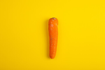 Fresh organic carrot on yellow background. Vegetables. Healthy food