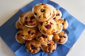 close up of muffins with chocolate and raspberries