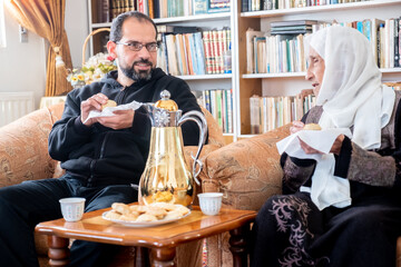 happy muslim Family served with arabic coffee during eid mubarak celebration